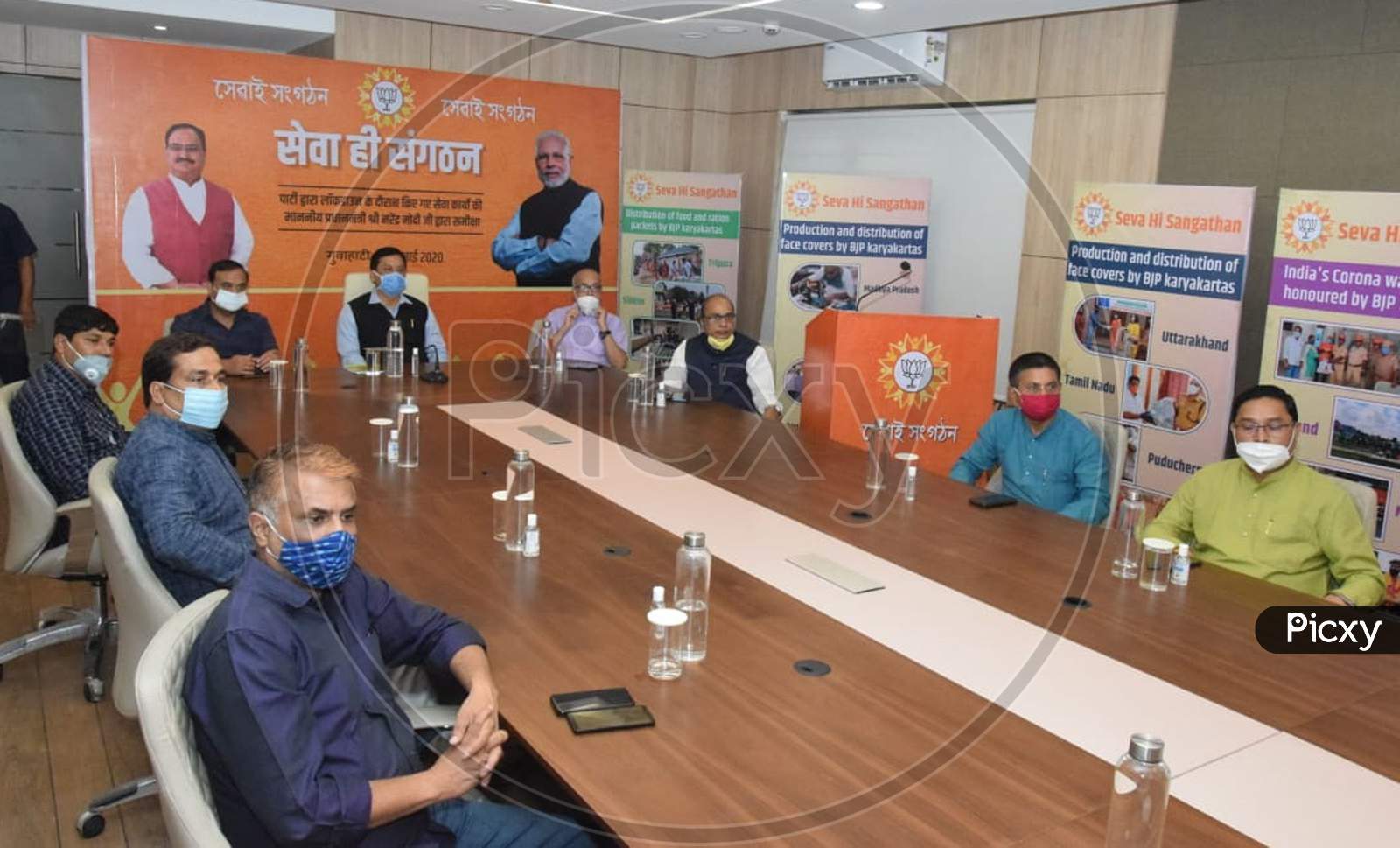 Assam Chief Minister Sarbananda Sonowal and State Finance, Health and Family Welfare Minister Himanta Biswa Sarma accompanied by party workers wearing face masks attend the Party's 'Seva Hi Sangathan Abhiyan' using video conferencing in Kamrup, Assam on July 04, 2020.