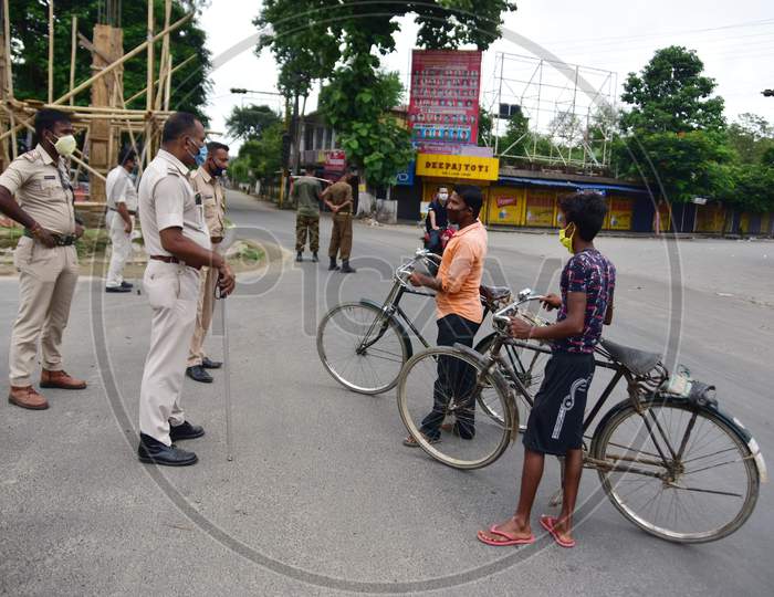 Police officers question commuters during the lockdown imposed by the Assam government to curb the spread of coronavirus in Nagaon, Assam on July 04, 2020