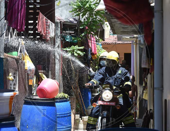 Firefighters on motorbikes spray disinfectants in a containment zone during the fifth phase of lockdown in Chennai