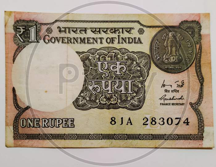 Old currency note of one rupee of India.
