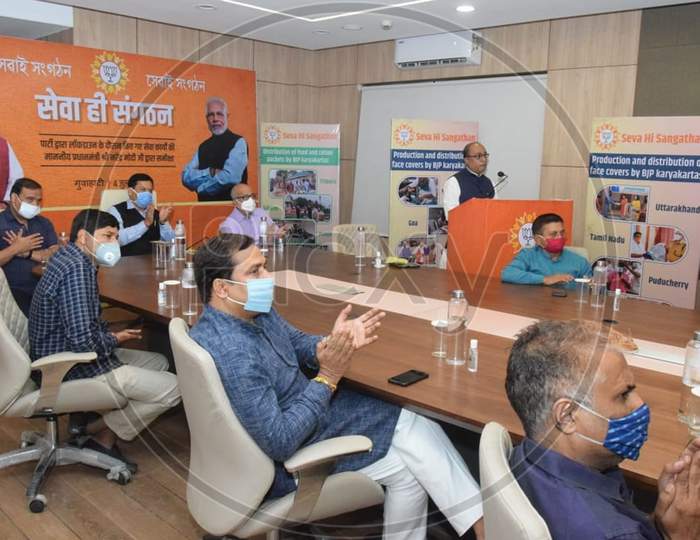 Assam Chief Minister Sarbananda Sonowal and State Finance, Health and Family Welfare Minister Himanta Biswa Sarma accompanied by party workers wearing face masks attend the Party's 'Seva Hi Sangathan Abhiyan' using video conferencing in Kamrup, Assam on July 04, 2020