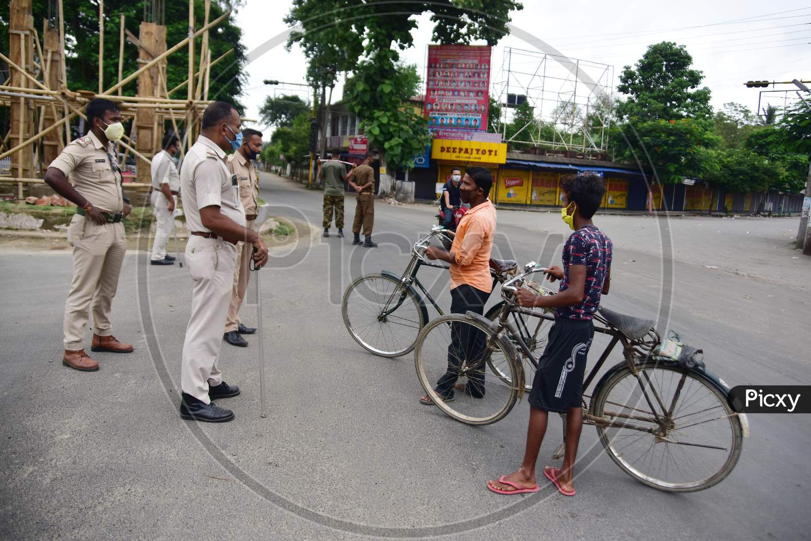 Police officers question commuters during the lockdown imposed by the Assam government to curb the spread of coronavirus in Nagaon, Assam on July 04, 2020