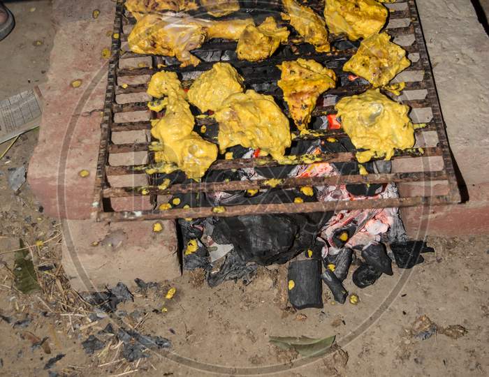 Marinated Chicken Preparing On A Barbecue Grill Over Charcoal. Chicken Meat Pieces On Grill.