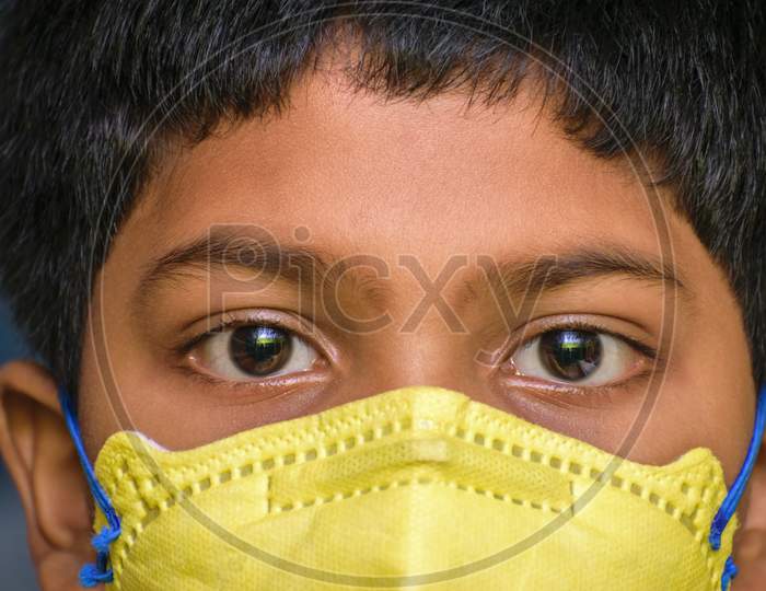 Isolated Young Indian Boy With Prominent Eyes Wearing N95 Face Mask For Protection Against Covid 19