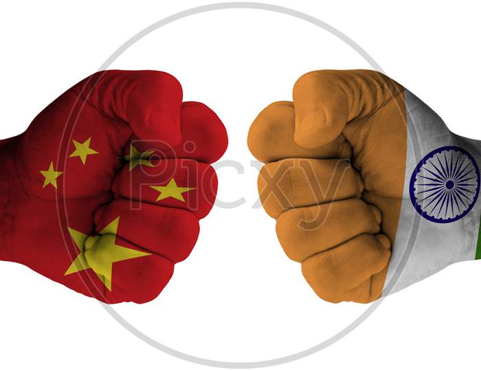 Conflict and tension between India and China on the border, male fists with India flag painted on skin - fight and conflict between two countries concept