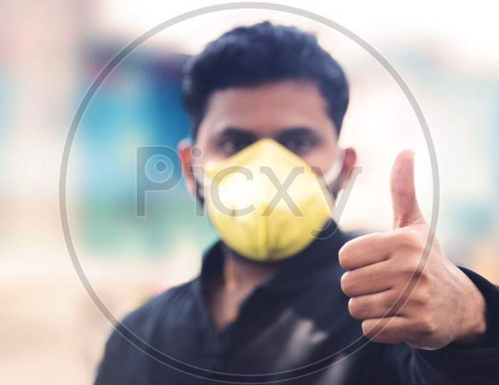 Man Covering His Face With Pollution Mask For Protection From Viruses During Corona Virus And Flu Outbreak. Virus And Illness Protection