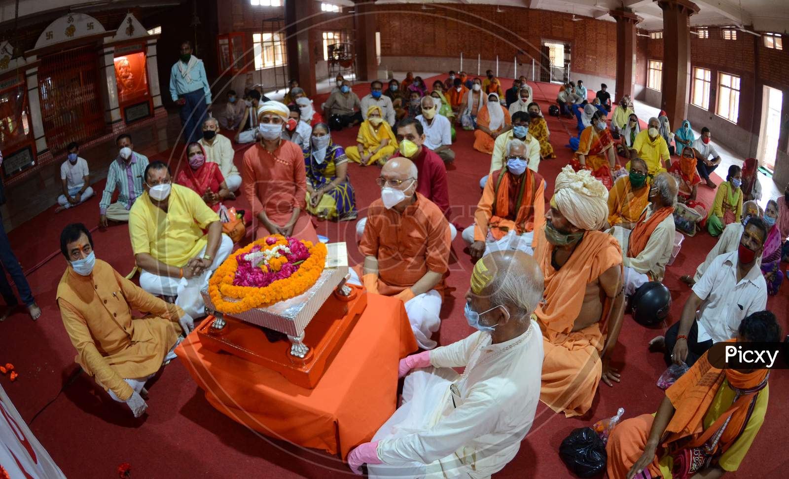 Followers of Swam Vasudevanand Saraswati listen to his sermons on the occasion of Guru Purnima in Prayagraj, Uttar Pradesh on July 07, 2020