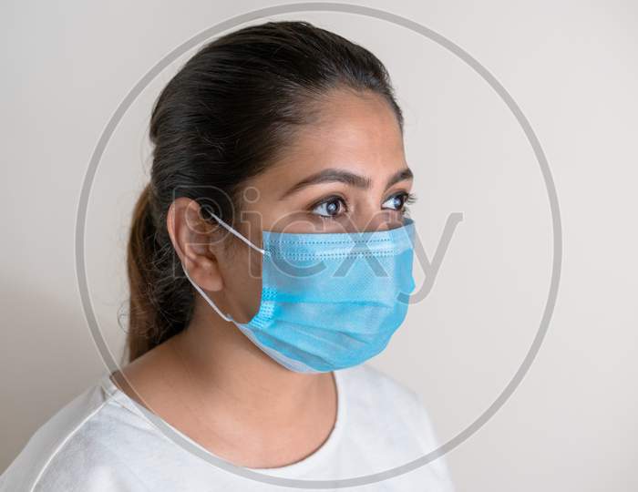 Responsible Indian woman wearing anti virus mask to prevent the spread of respiratory illness by corona virus