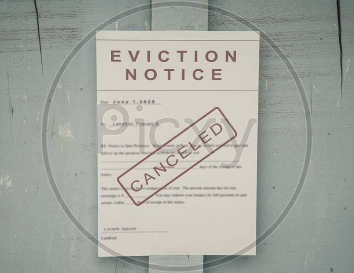 Canceled Foreclosed Or Eviciton Notice On A Main Door With Blurred Details Of A House With Vintage Filter.