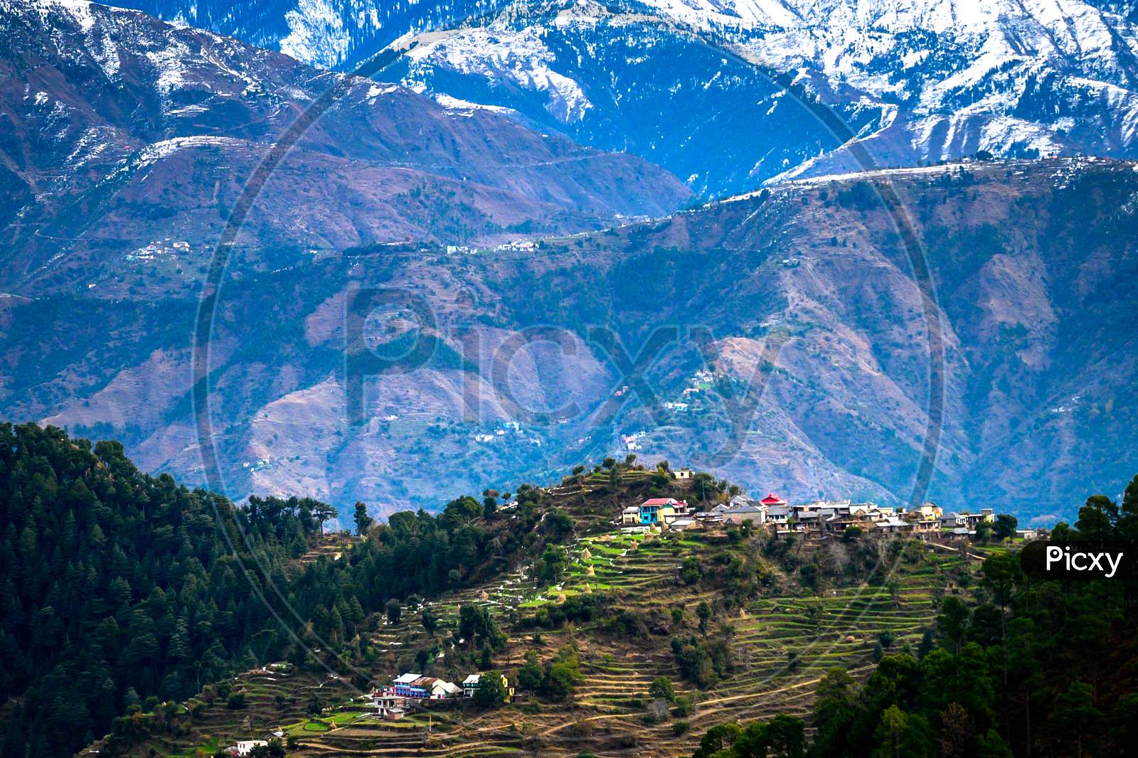 A scenic village in the backdrop of the Himalayan mountains. Himachal Pradesh, India.