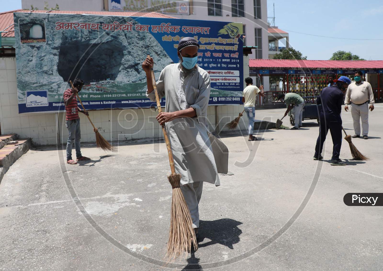 Workers clean the premises at the base camp of Amarnath Yatra in Jammu on July 05, 2020