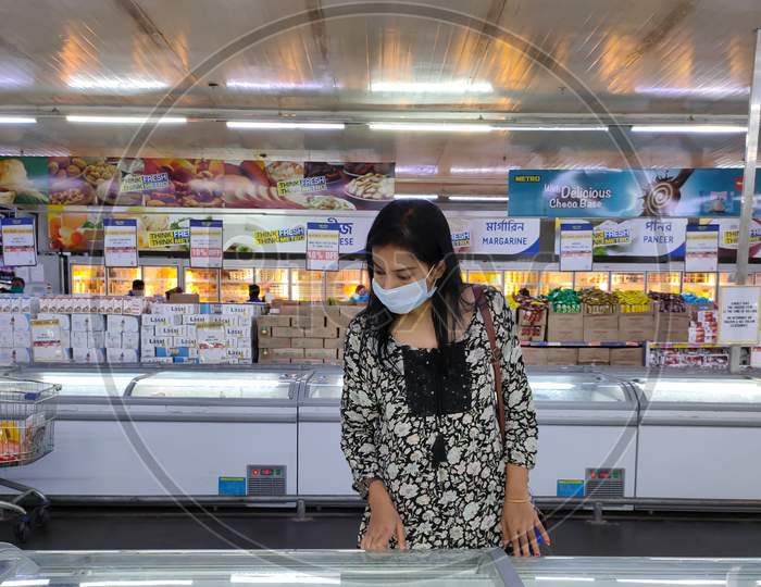 Lady With Mask On Face Buying Grocery At Super Market.