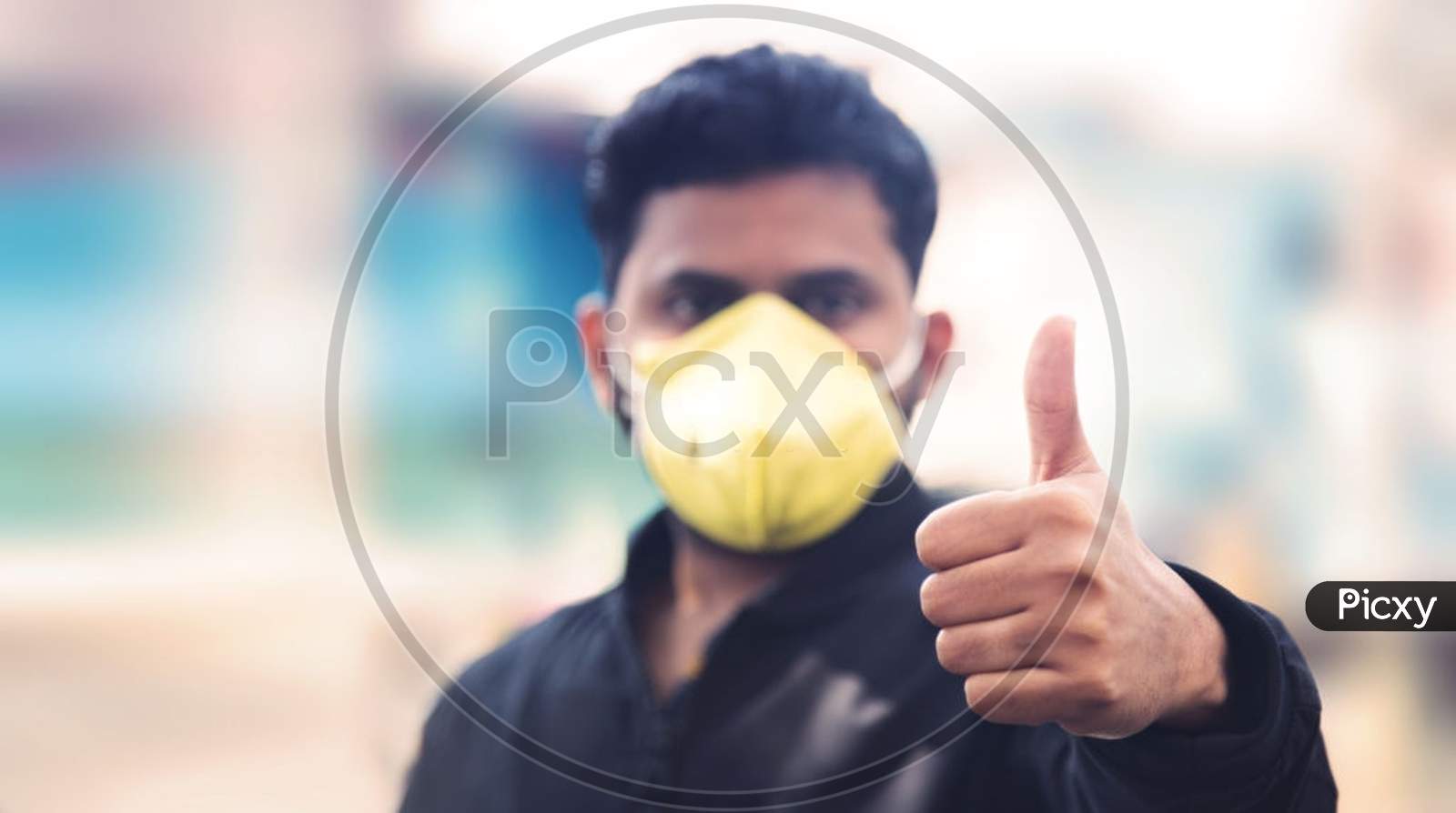 Man Covering His Face With Pollution Mask For Protection From Viruses During Corona Virus And Flu Outbreak. Virus And Illness Protection