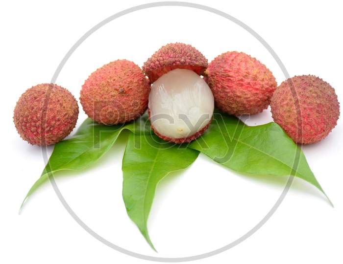 bunch the red ripe litchi with green leaves isolated on white background.