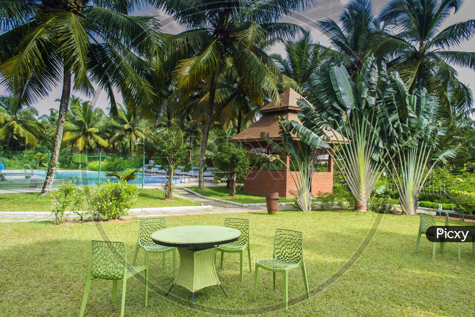 Chairs And Table In A Lawn In Front Of Swimming Pool