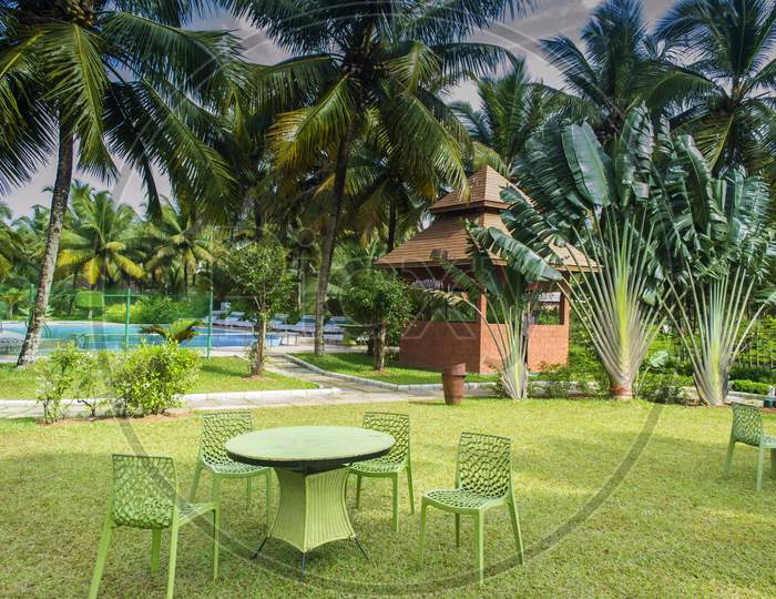 Chairs And Table In A Lawn In Front Of Swimming Pool