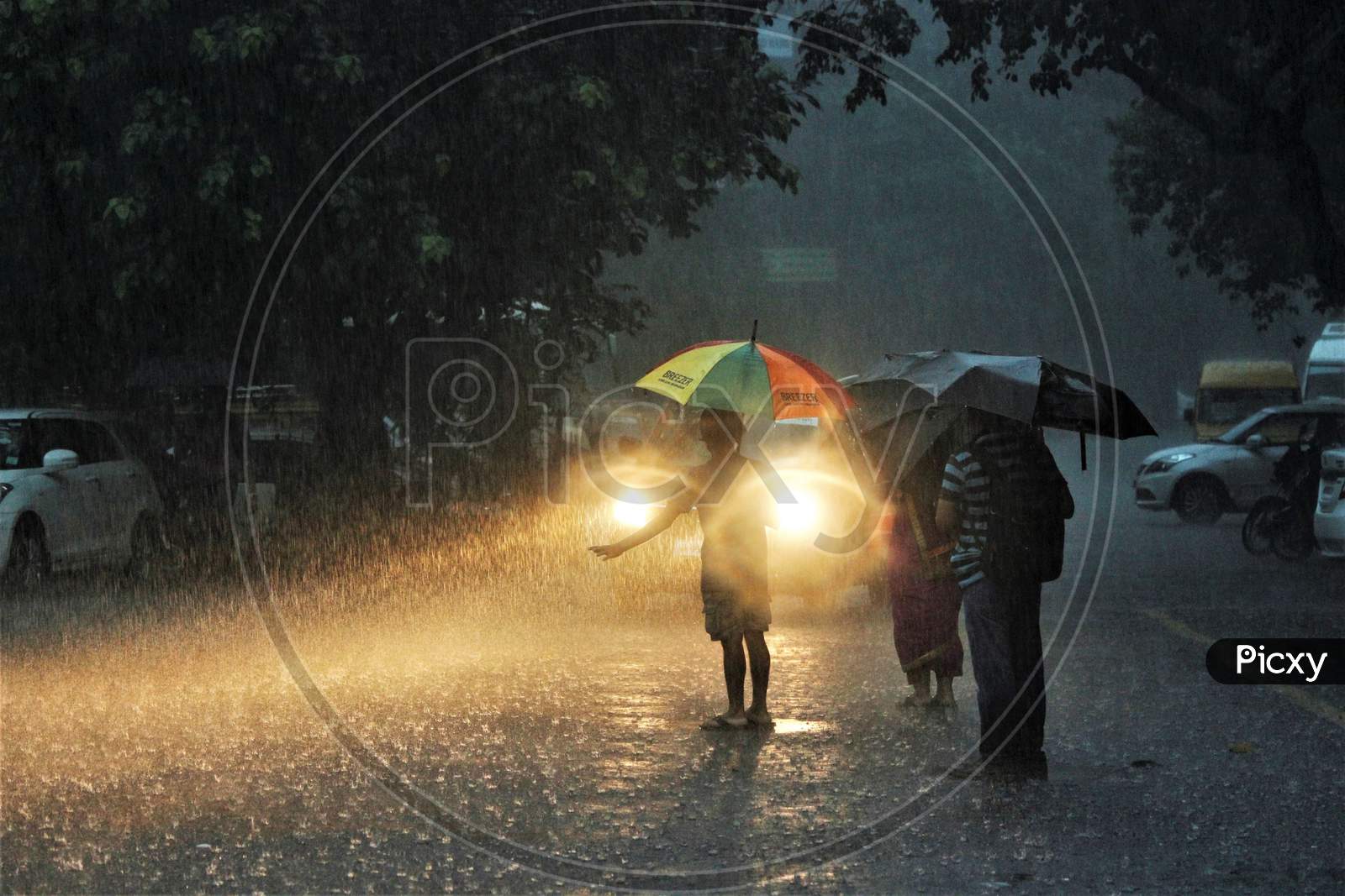 People wait for a taxi during heavy rains, in Mumbai on July 4, 2020.