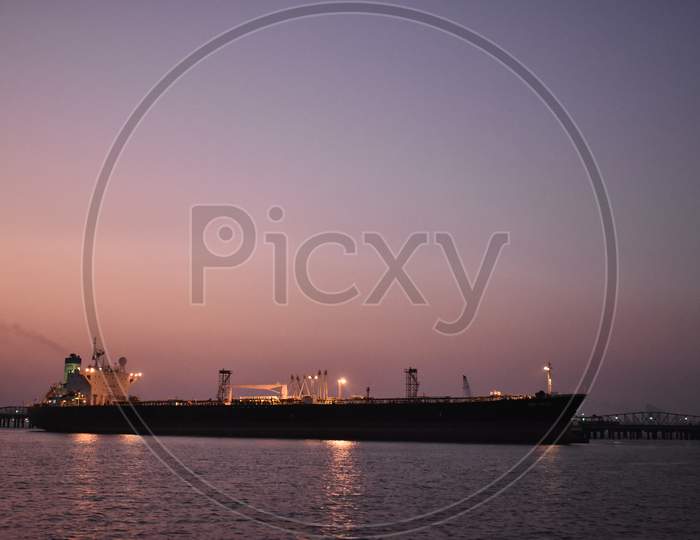 Silhouette Image Of A Merchant Ship Standing In A Port