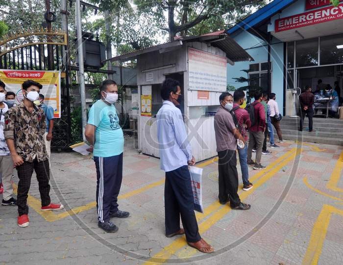 People wait in a queue to get tested for Coronavirus outside a government hospital in Guwahati, Assam on July 06, 2020.