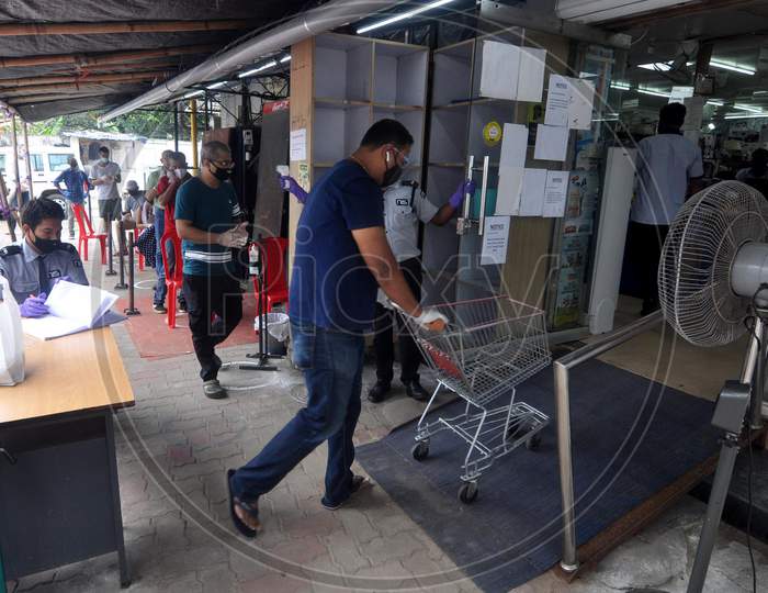 People maintain social distance in a grocery shop during the lockdown in Guwahati, Assam on July 06, 2020.