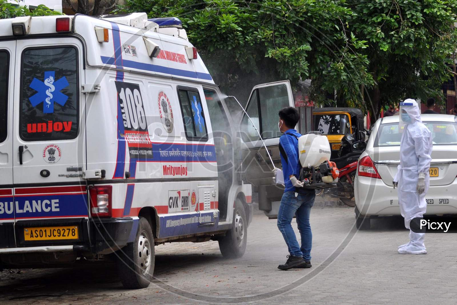 A health worker sprays disinfectant on an ambulance outside a government hospital in Guwahati, Assam on July 06, 2020.