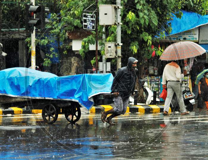 A man pulls a handcart during heavy rains, in Mumbai on July 4, 2020.