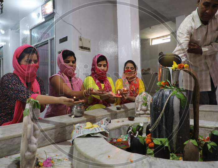 Devotees offer their prayers at a Shiva temple on the first Monday of the auspicious month of 'Shravan' in Jammu on July 05, 2020