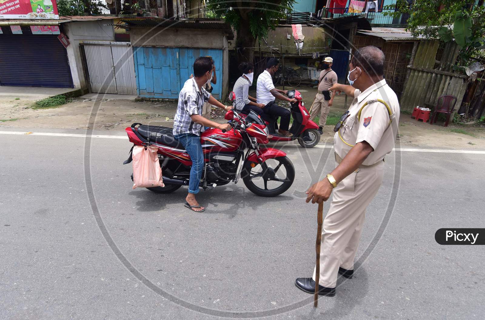Police question bike riders during the lockdown imposed to curb the spread of Coronavirus in Nagaon, Assam on July 05, 2020