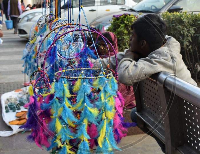 08 Dec 2019- A child selling colourful dream catchers, Connaught Place photo, New Delhi.