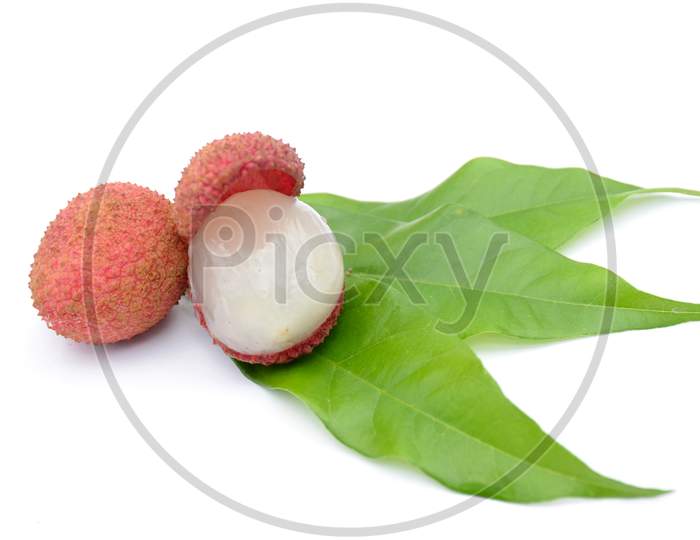 the red ripe litchi with green leaves isolated on white background.