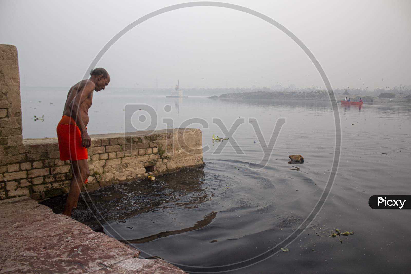 New Delhi, India - July 5 2018 : A Morning At Nigam Bodh Ghat Near Kashmiri Gate, An Old Person Going To Take A Dip In Holy Yamuna.