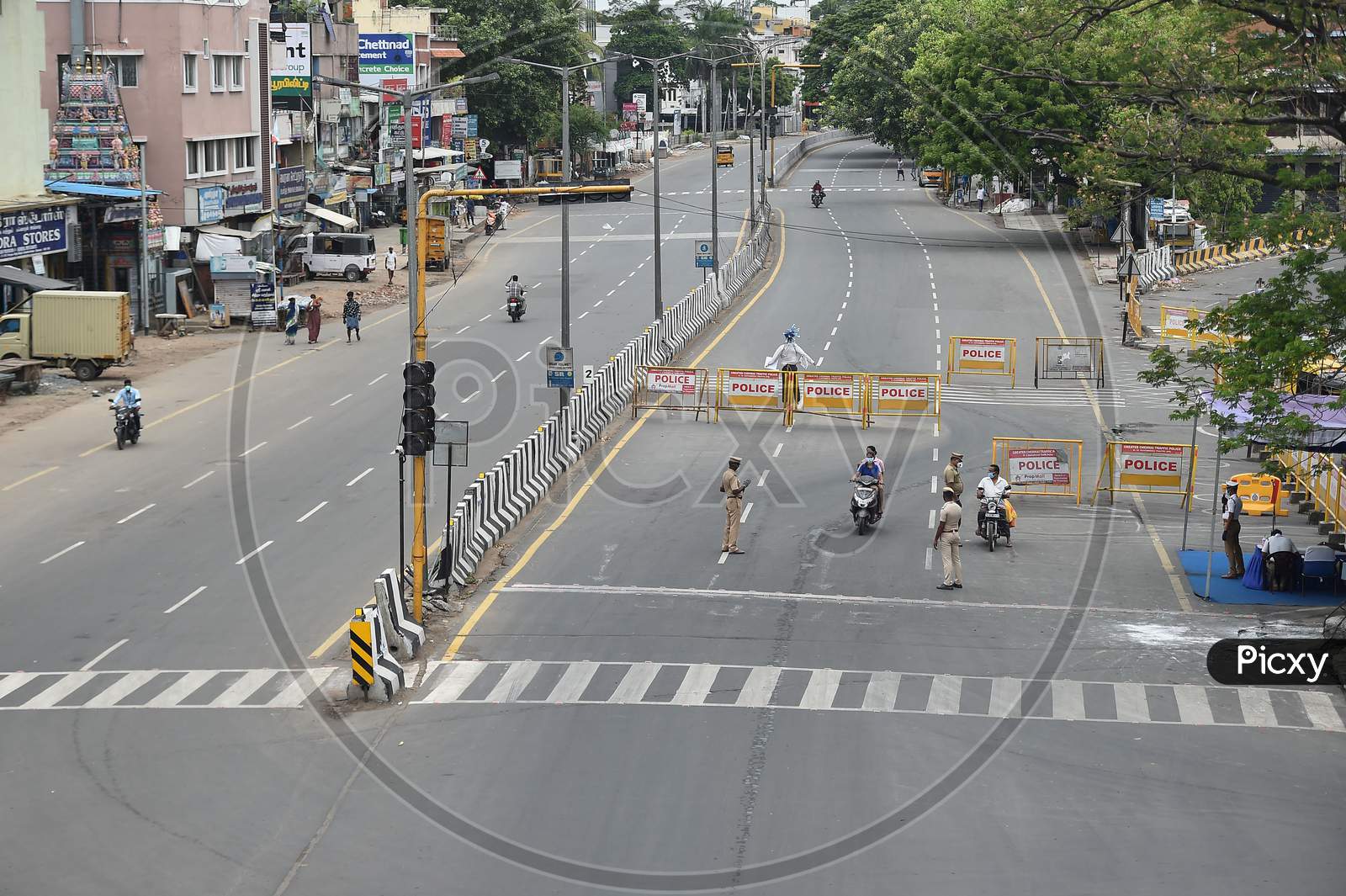 Police stop bike riders on a deserted road during the lockdown in Chennai on July 07, 2020