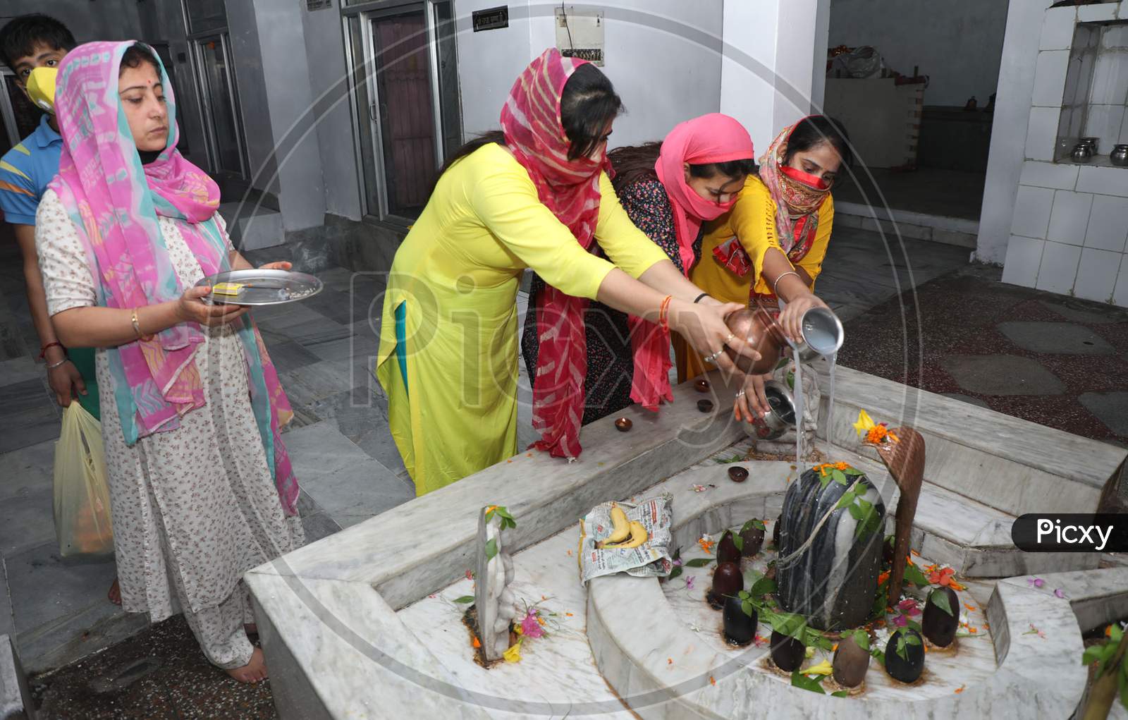Devotees offer their prayers at a Shiva temple on the first Monday of the auspicious month of 'Shrawan' in Jammu on July 05, 2020