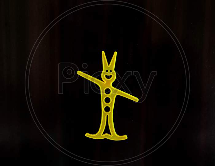 A Yellow Color Human Cartoon With Black Background.