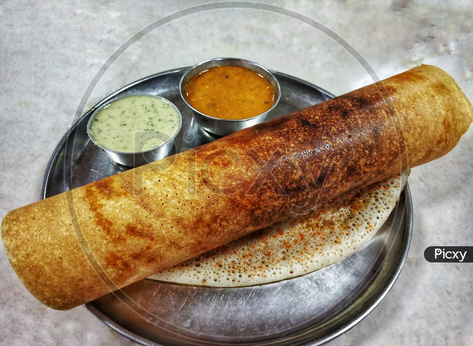 Masala Dosa With Chutney And Sambar Placed In A Steel Plate On A White Table. South Indian Breakfast.