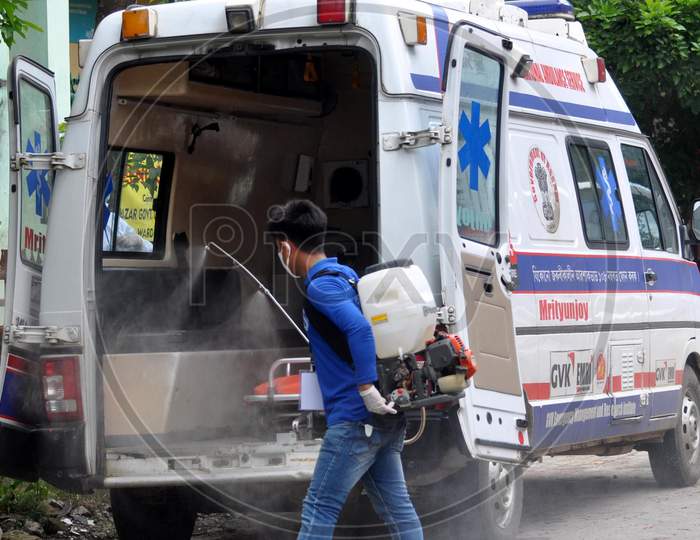 A health worker sprays disinfectant on an ambulance outside a hospital in Guwahati, Assam on July 06, 2020.
