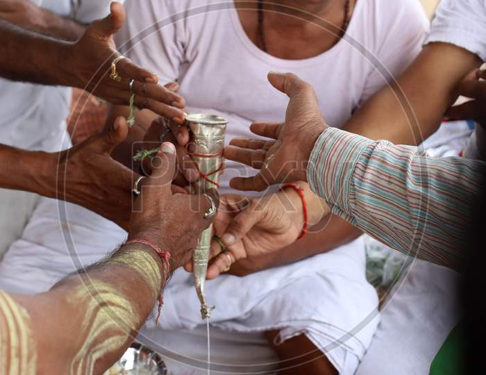 Hindu devotees offer prayers on the first Monday of the Sravan month on the banks of the River Ganga in Prayagraj, Uttar Pradesh on July 06, 2020