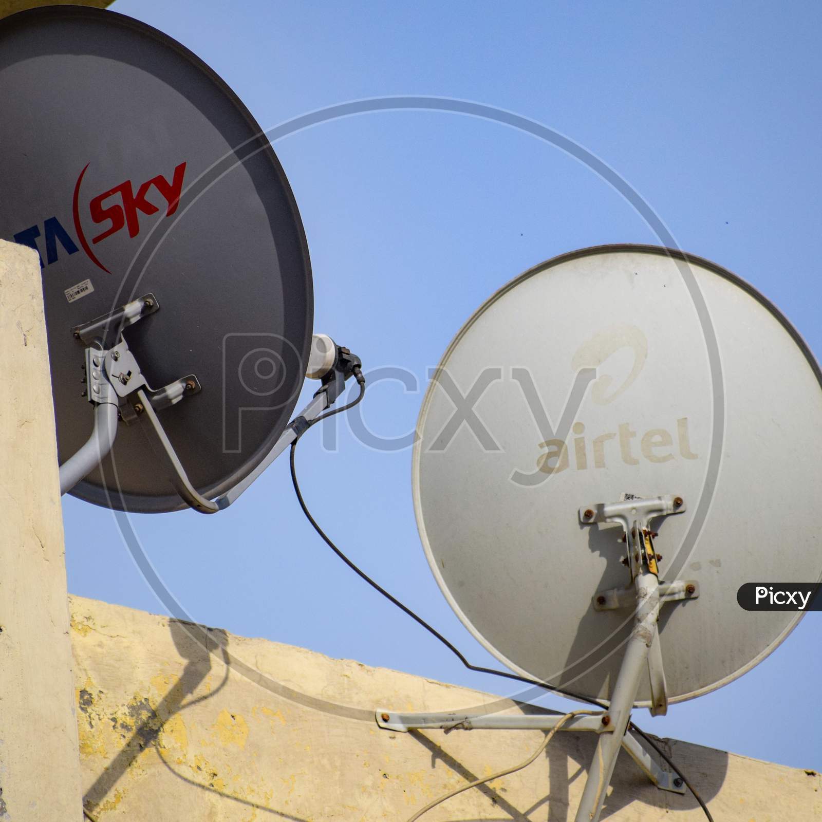 Delhi, 5 July 2020, India: Satellite dish and antenna of Dish TV, Tata sky, Videocon DTH and other DTH Providers on the roof of a building