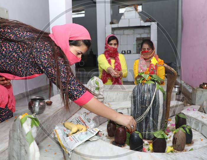 Devotees offer their prayers at a Shiva temple on the first Monday of the auspicious month of 'Shrawan' in Jammu on July 05, 2020