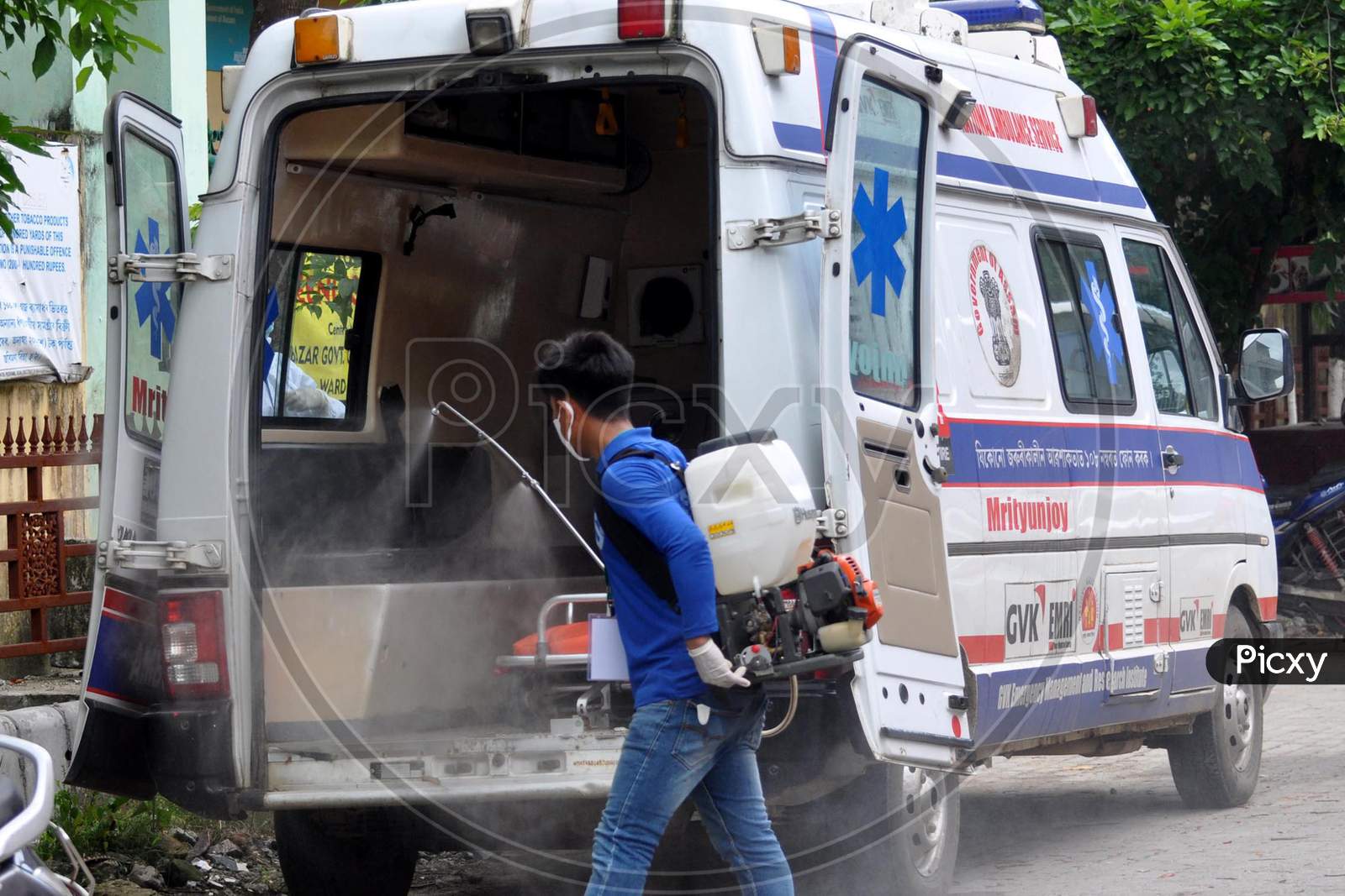 A health worker sprays disinfectant on an ambulance outside a hospital in Guwahati, Assam on July 06, 2020.