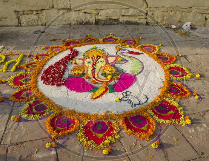 rangoli pattern making during dev diwali celebration