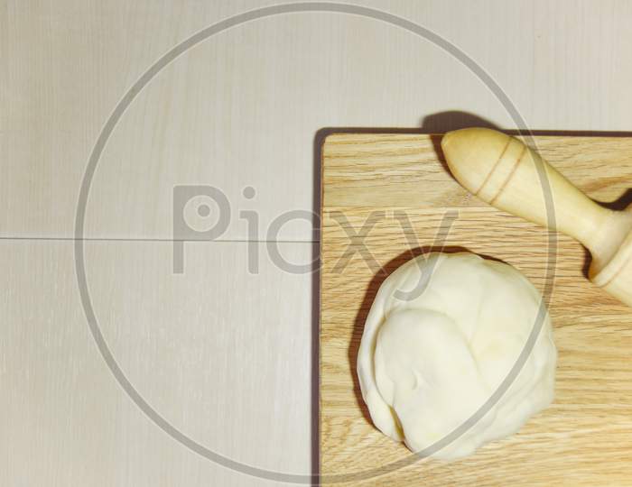 Focus On The Chopping Board And Blury Dough And Roller. Cooking Concept