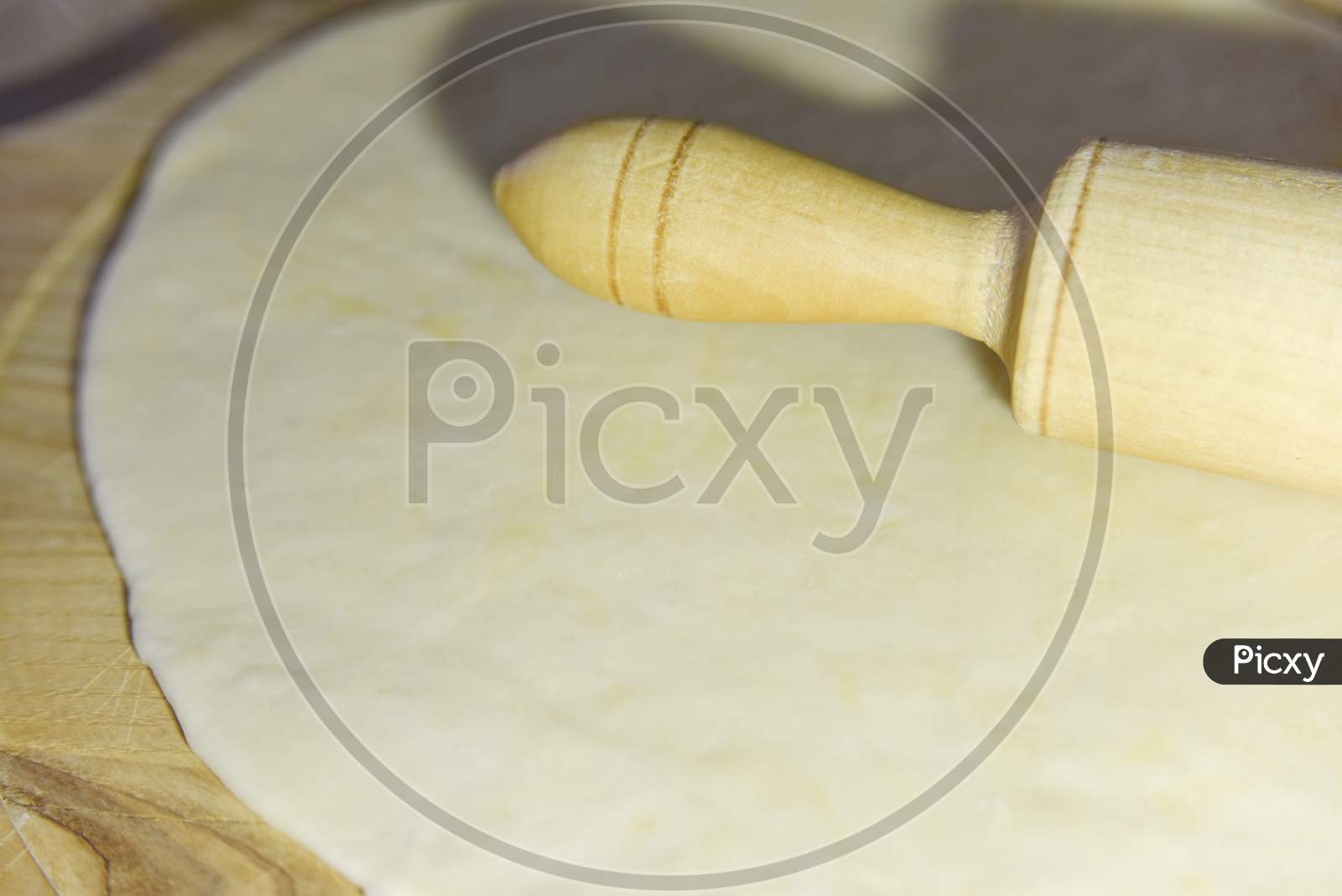 Selective Focus At The Dough And Roller On The Chopping Board
