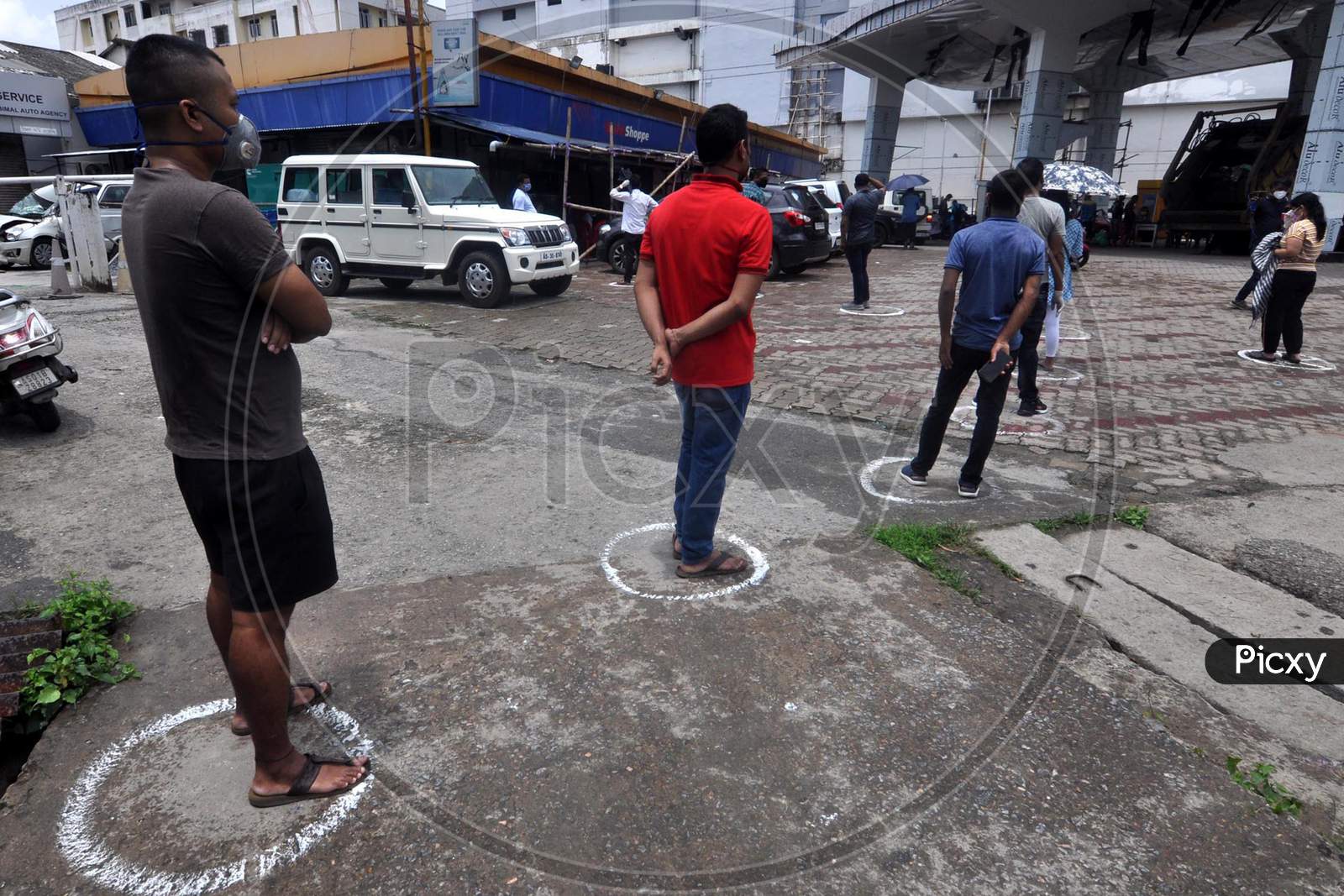 People maintain social distance outside a grocery shop during the lockdown in Guwahati, Assam on July 06, 2020.