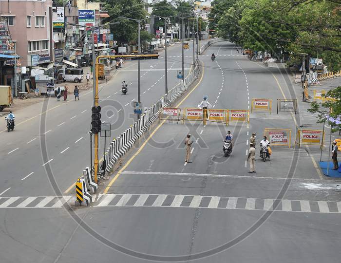 Police stop bike riders on a deserted road during the lockdown in Chennai on July 07, 2020