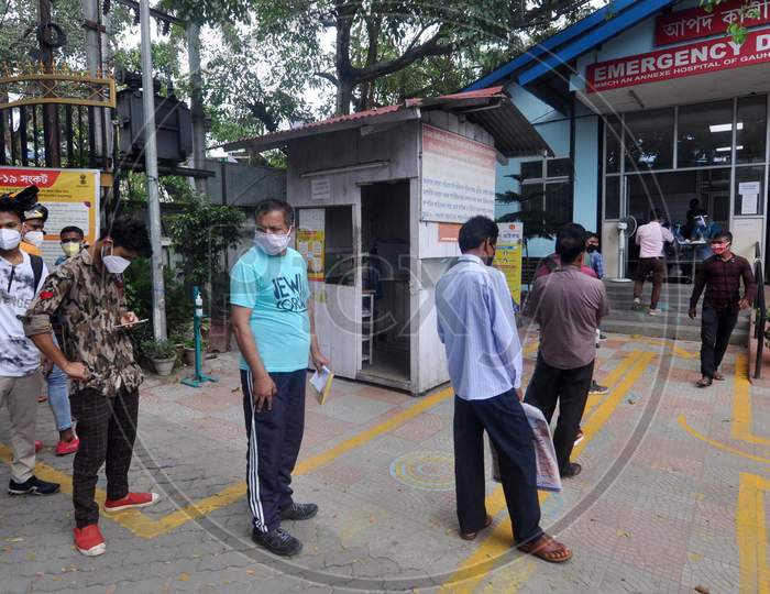 People stand in a queue outside the government hospital to get tested for Coronavirus in Guwahati, Assam on July 07, 2020.