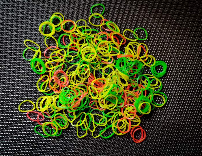 Bunch Of Color Rubber Bands Isolated On Black Background.