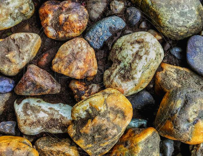 Colorful Pebbles Stones Near A River In Western Ghats.