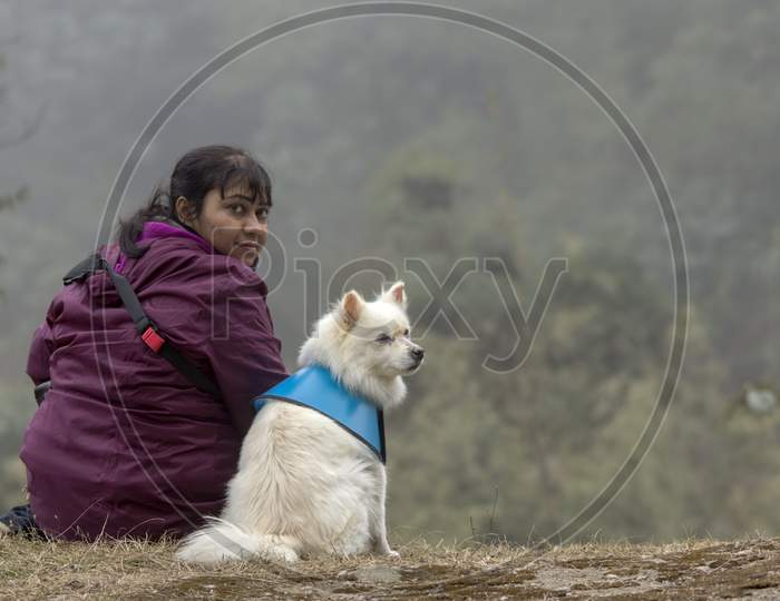 A Female Model Sitting With A Dog