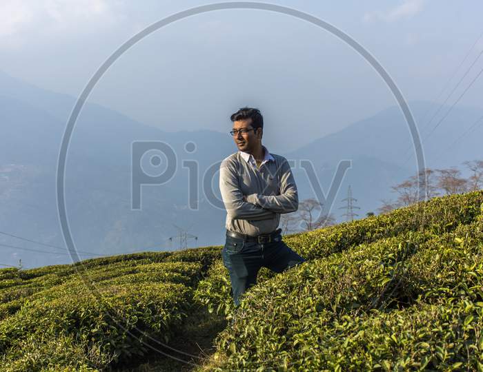 A Young Indian Male Model Standing In Tea Garden
